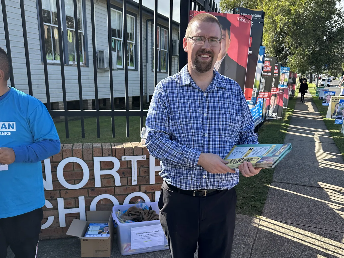 A Democrats volunteer handing out how-to-vote cards at a NSW polling place
